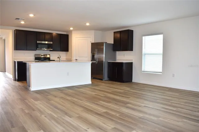 a view of a kitchen with microwave and cabinets