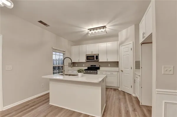 a kitchen with cabinets and a stove top oven