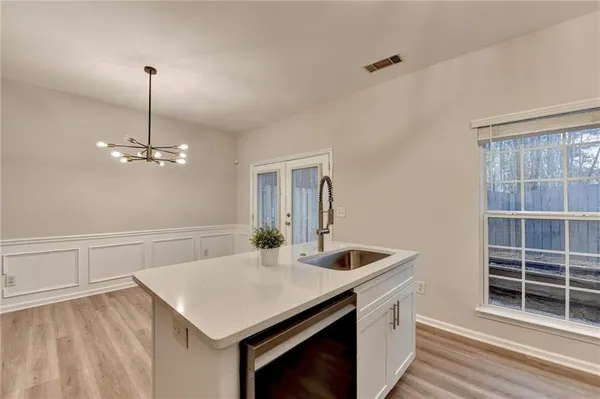 a kitchen with a center island a stove cabinets and wooden floor