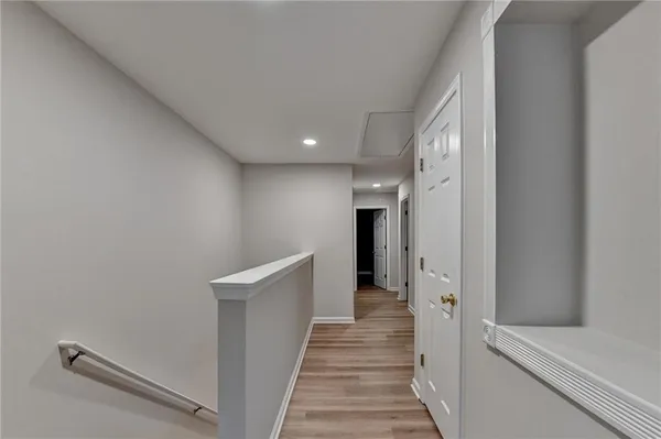 a view of a hallway with wooden floor