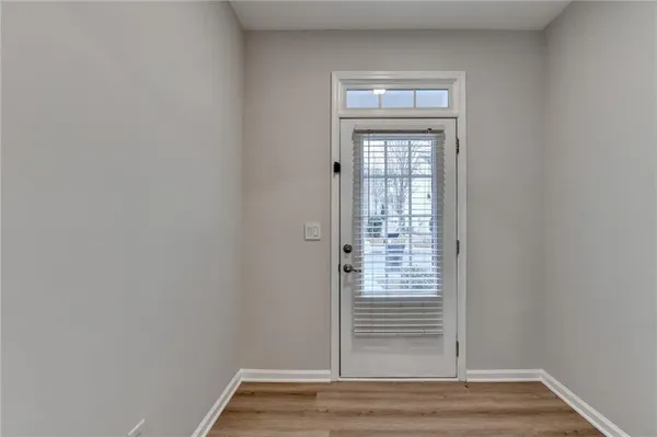 a view of empty room with wooden floor