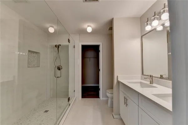 a bathroom with a shower sink and mirror