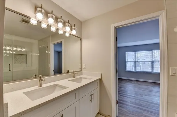 a bathroom with a sink double vanity and a mirror