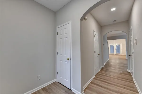 a view of a hallway with wooden floor