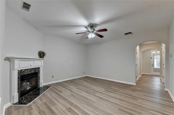 wooden floor in an empty room with a fireplace