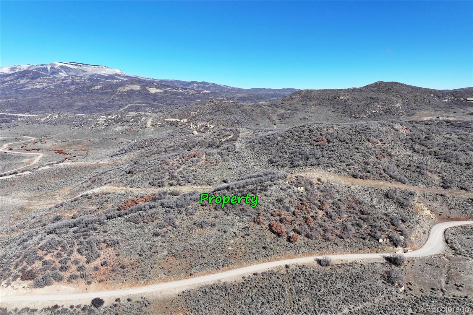 0 Harrison Gulch Road Collbran, CO 81624 - Photo 10 of 11 a view of a dry field with mountains in the background