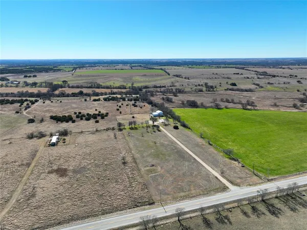 an outdoor space with wooden floor and city view