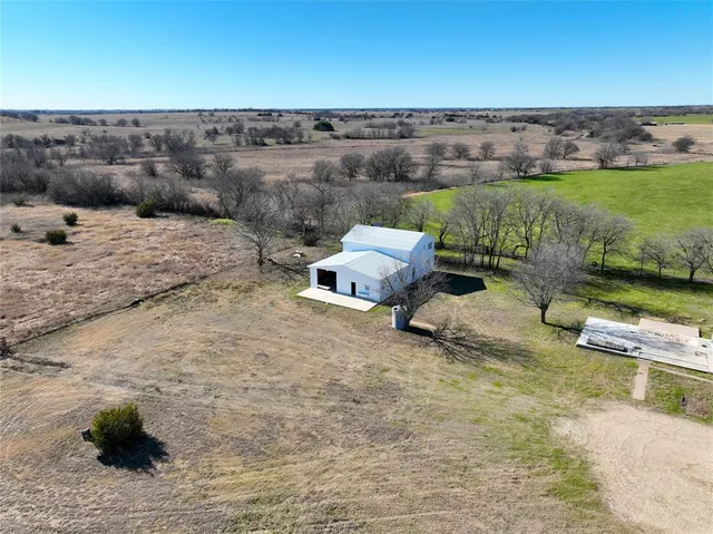 an aerial view of a houses with a yard