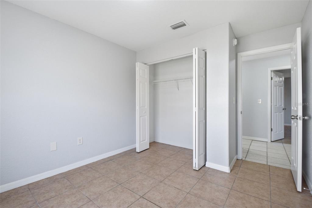 6018 Flora Terrace Apollo Beach, FL 33572 - Photo 18 of 33 an empty room with closet and mirror