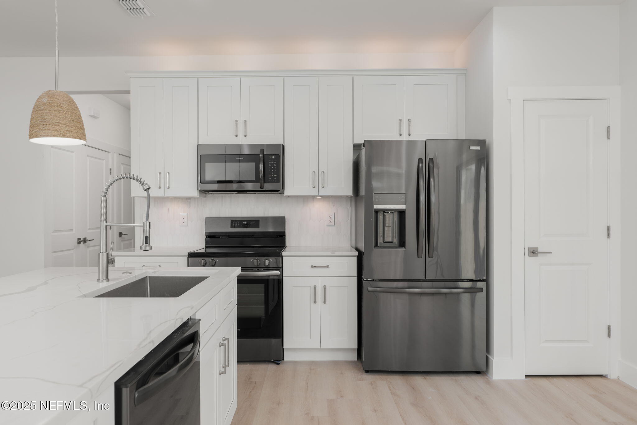 603 Twenty Second Street St. Augustine, FL 32084 - Photo 14 of 36 a kitchen with appliances a sink and a refrigerator