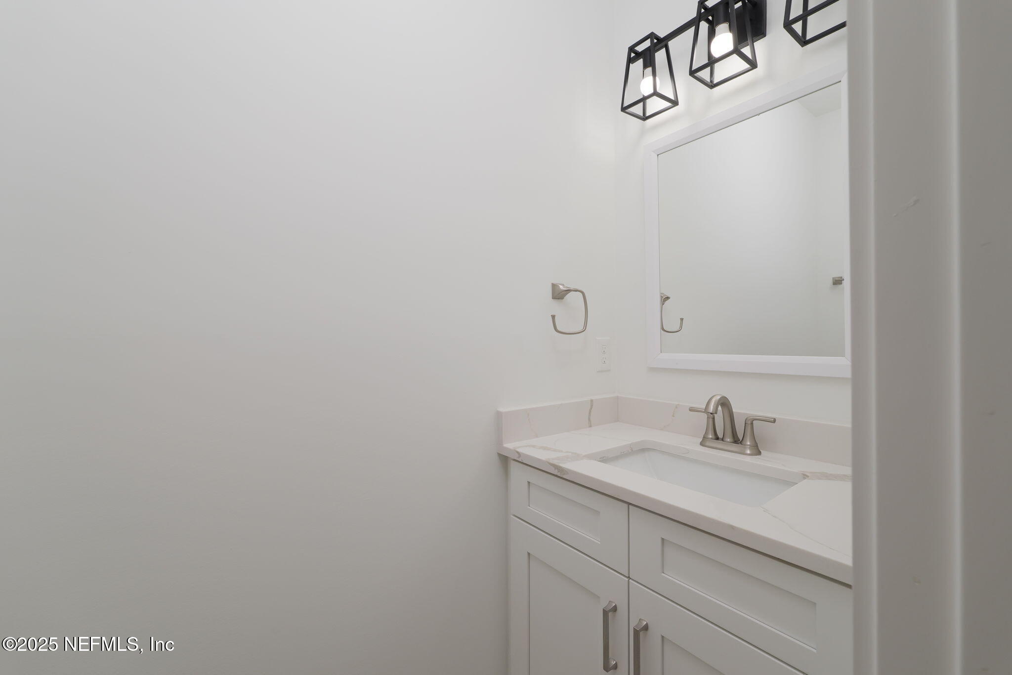 603 Twenty Second Street St. Augustine, FL 32084 - Photo 16 of 36 a bathroom with a sink and vanity