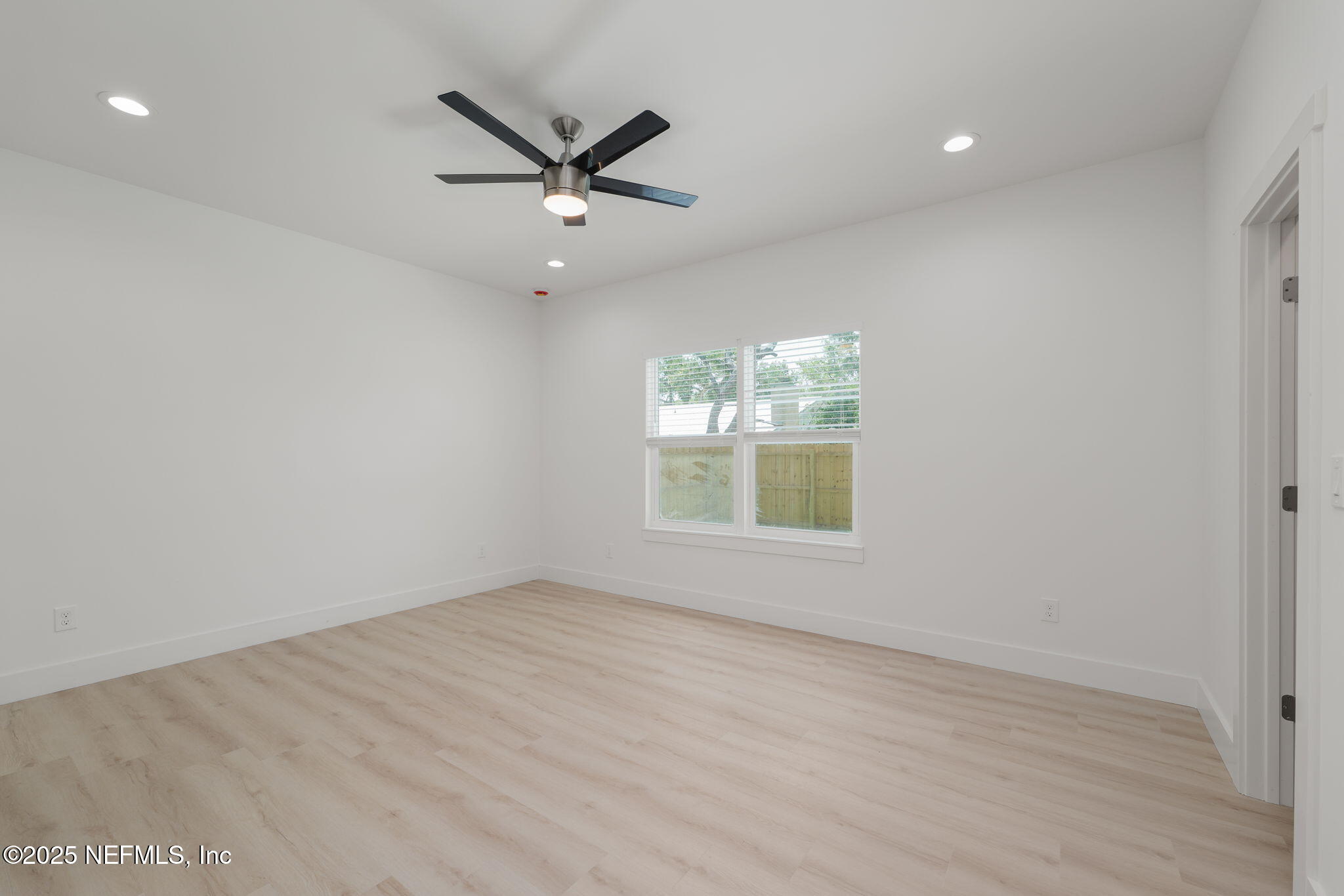 603 Twenty Second Street St. Augustine, FL 32084 - Photo 17 of 36 an empty room with windows and ceiling fan