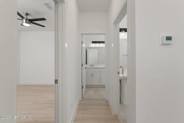 a view of a bathroom from a hallway