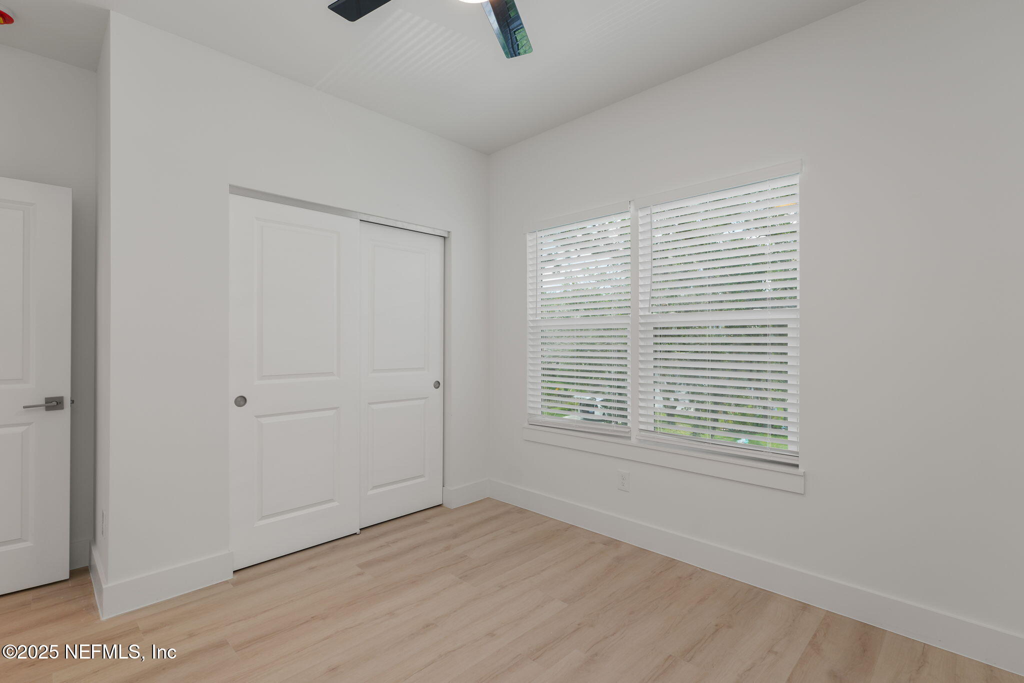 603 Twenty Second Street St. Augustine, FL 32084 - Photo 24 of 36 a view of an empty room with wooden floor and a window