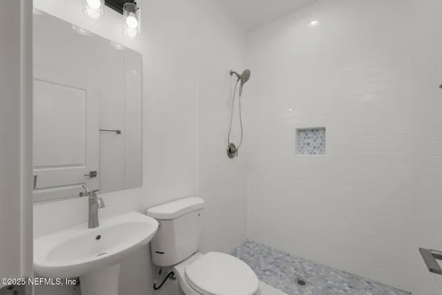 a bathroom with a sink toilet and a mirror