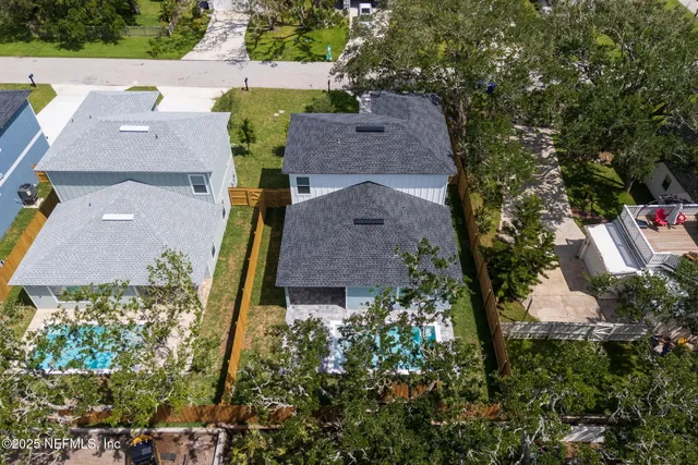 an aerial view of multiple houses with yard
