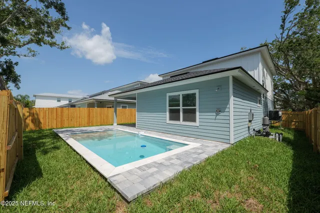 a backyard of a house with table and chairs
