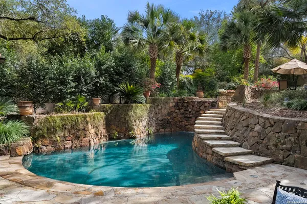 a view of a yard with wooden fence
