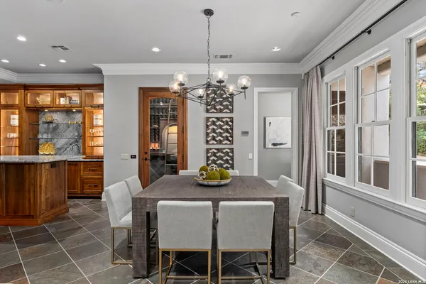 a living room with furniture a chandelier and a flat screen tv