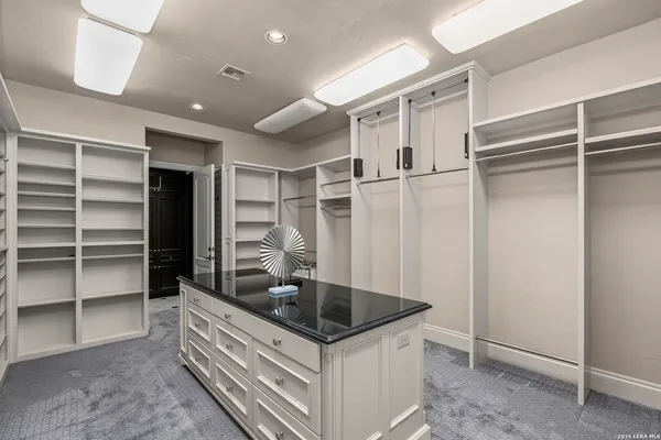 a bathroom with a granite countertop sink toilet mirror and shower