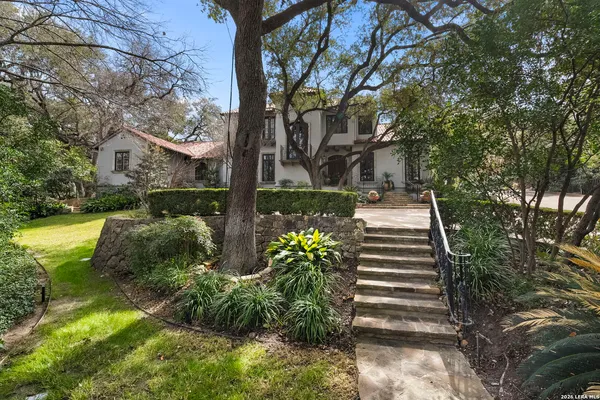 a view of a large trees in front of a house