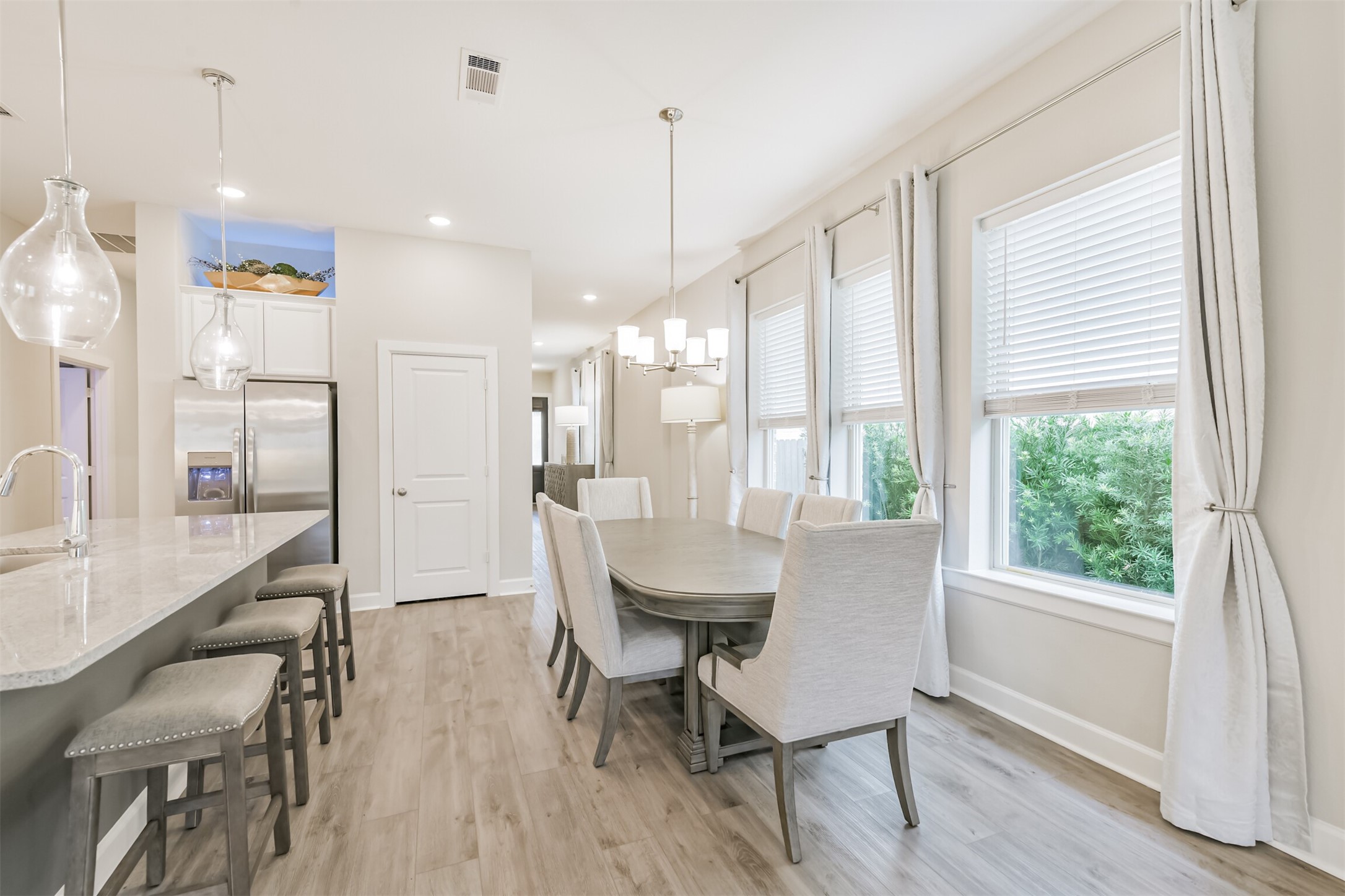 15611 Rising Wren Court Conroe, TX 77302 - Photo 13 of 38 a view of a dining room with furniture window and wooden floor
