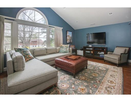 21 Lawrence Lane Lexington, MA 02421 - Photo 7 of 18 a living room with furniture a large window and a flat screen tv