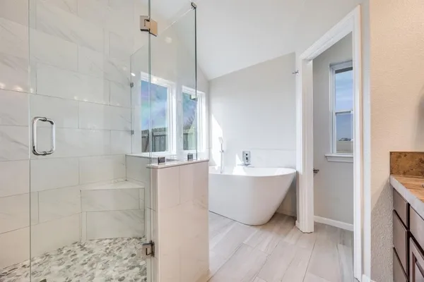 a bathroom with a bathtub and shower