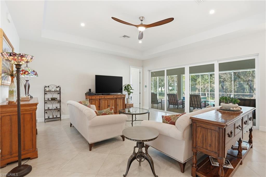 3707 5th Avenue Southwest Naples, FL 34117 - Photo 14 of 45 Living room featuring ceiling fan, recessed lighting, a raised ceiling, and light tile patterned floors