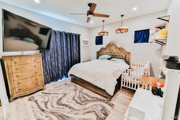 a bedroom with a bed a dresser and book shelf