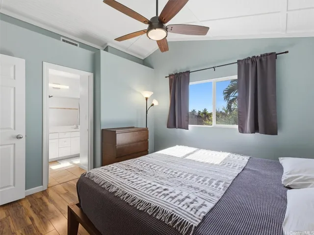 an aerial view of a house with garden space and a lake view