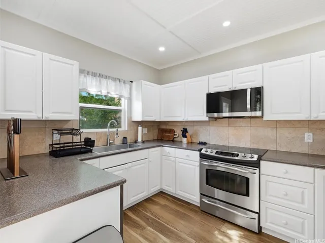 a bathroom with a sink a toilet and shower curtain