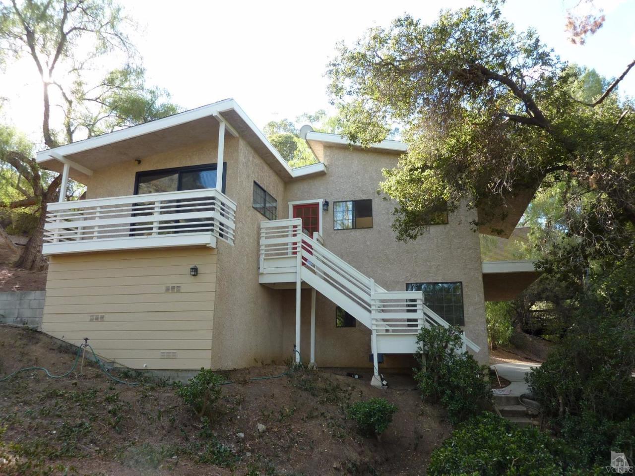 1040 Black Canyon Road Simi Valley, CA 93063 - Photo 3 of 33 a front view of a house with a garage