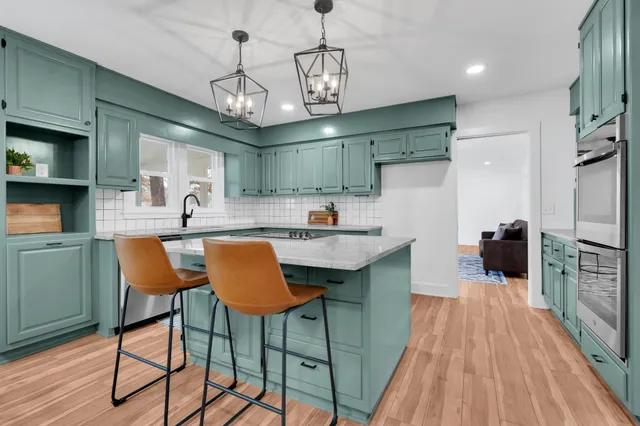 a kitchen with stainless steel appliances granite countertop a stove a microwave and cabinets