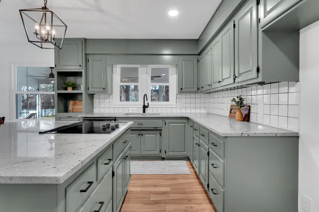 a kitchen with granite countertop a sink and cabinets