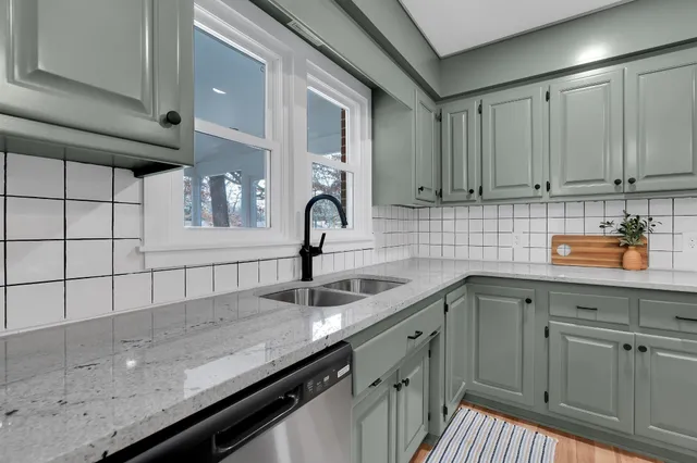 a dining room filled chandelier and wooden floor