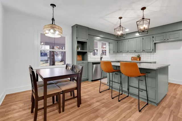 a view of a room with wooden floor fan and window