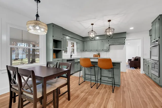 a bathroom with a granite countertop toilet sink and mirror