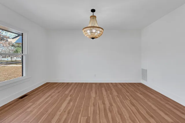 a view of room with wooden floor and cabinet