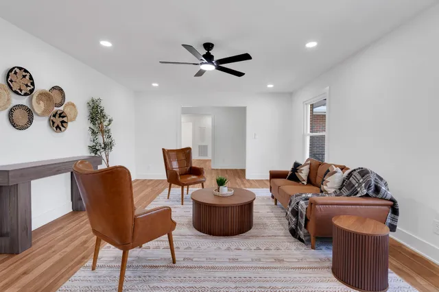 a living room with furniture and a wooden floor