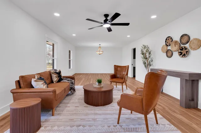 a living room with furniture and a wooden floor