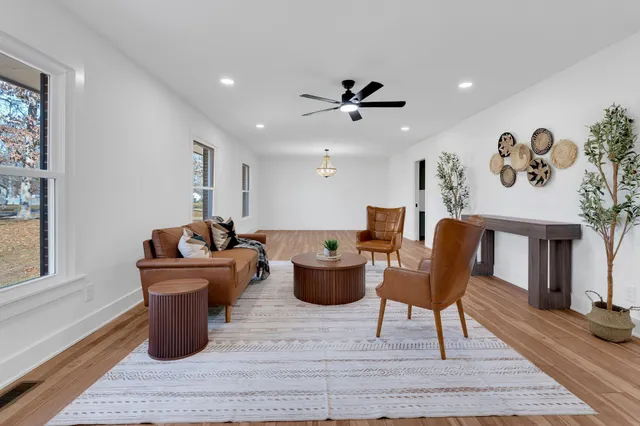 a living room with furniture and a wooden floor