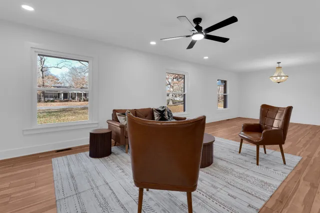 a view of a livingroom with furniture and a window