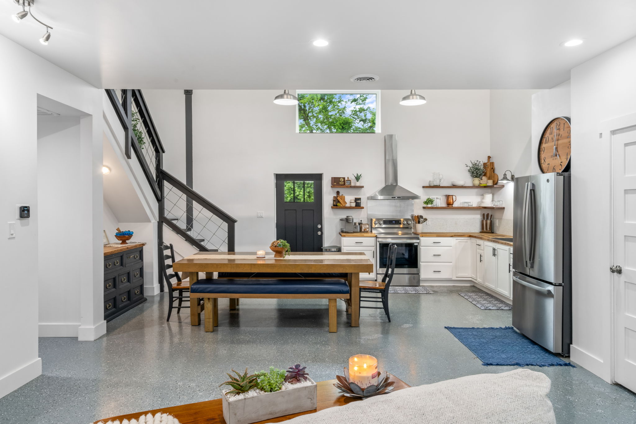 180 Henly Loop Dripping Springs, TX 78620 - Photo 11 of 38 a living room with furniture a rug and kitchen view