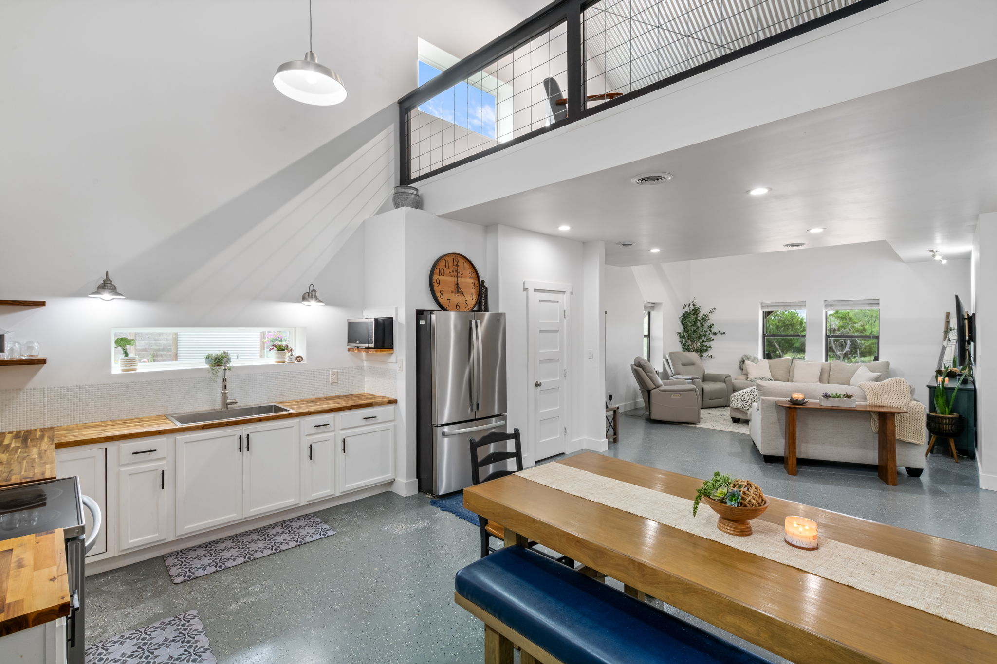 180 Henly Loop Dripping Springs, TX 78620 - Photo 14 of 38 a large kitchen with a table and chairs