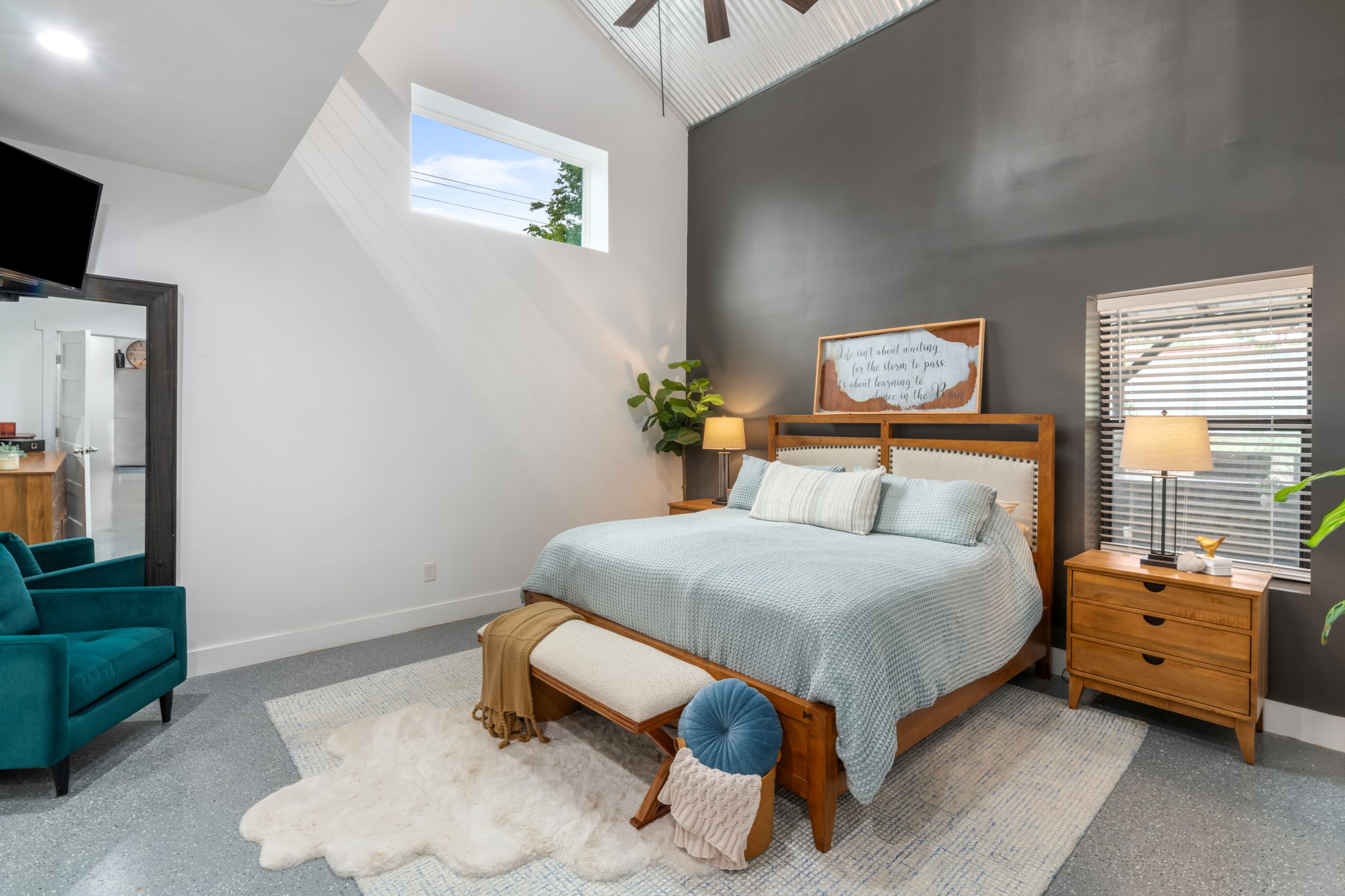 180 Henly Loop Dripping Springs, TX 78620 - Photo 16 of 38 a bedroom with a bed and a tv on the dresser