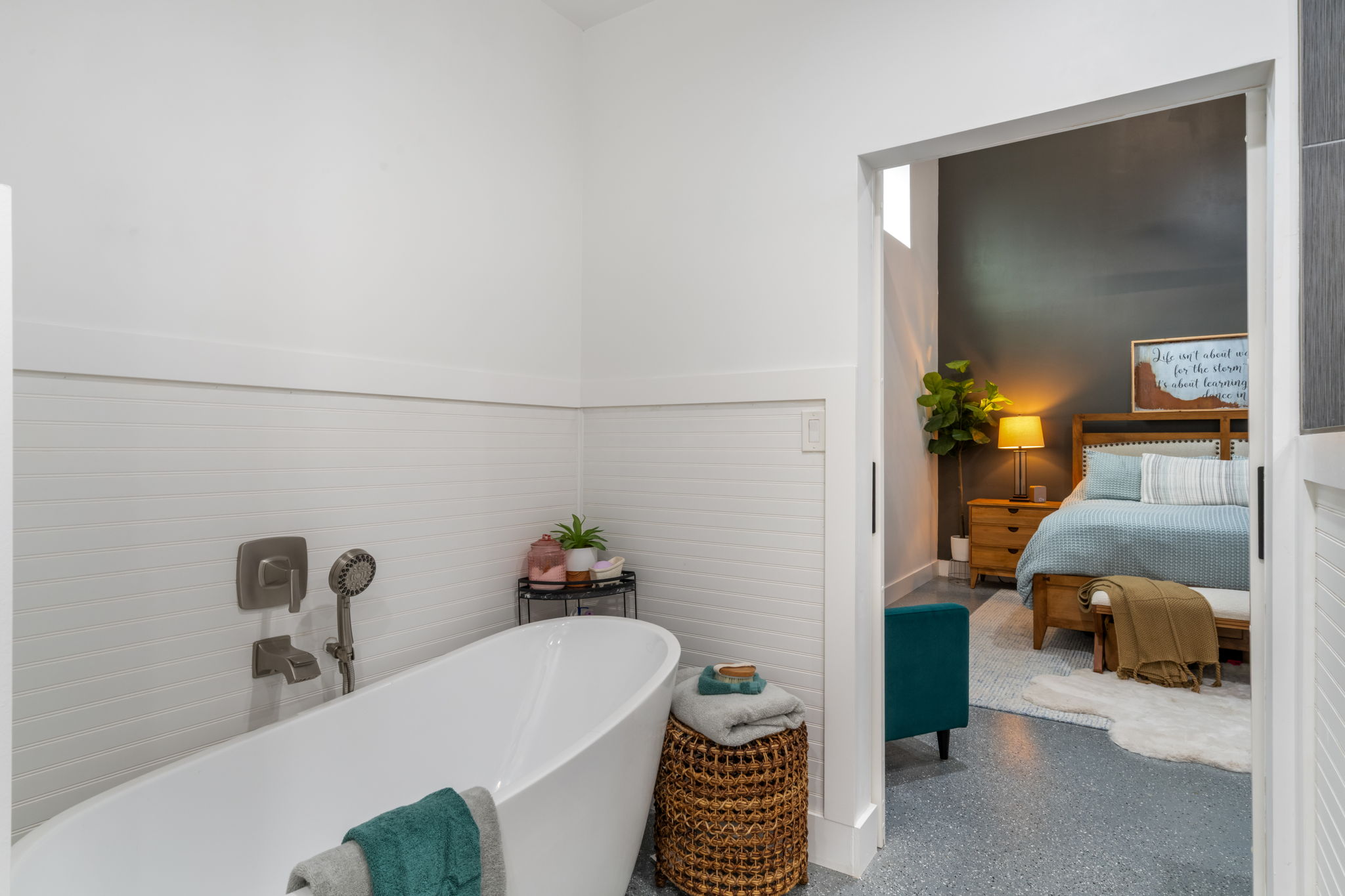 180 Henly Loop Dripping Springs, TX 78620 - Photo 20 of 38 a bedroom with a bed and wooden floor