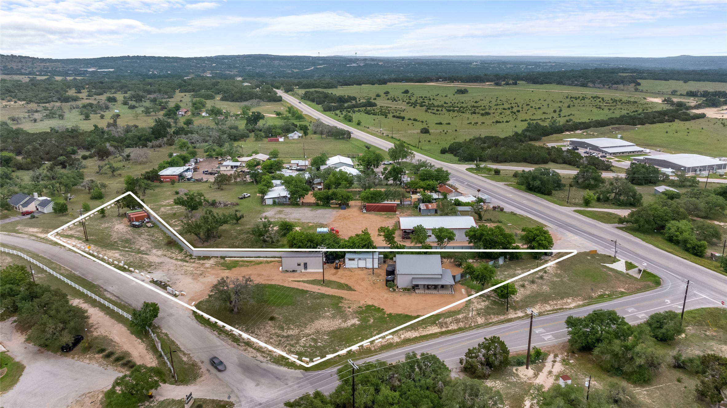180 Henly Loop Dripping Springs, TX 78620 - Photo 2 of 38 an aerial view of a house with a garden and lake view
