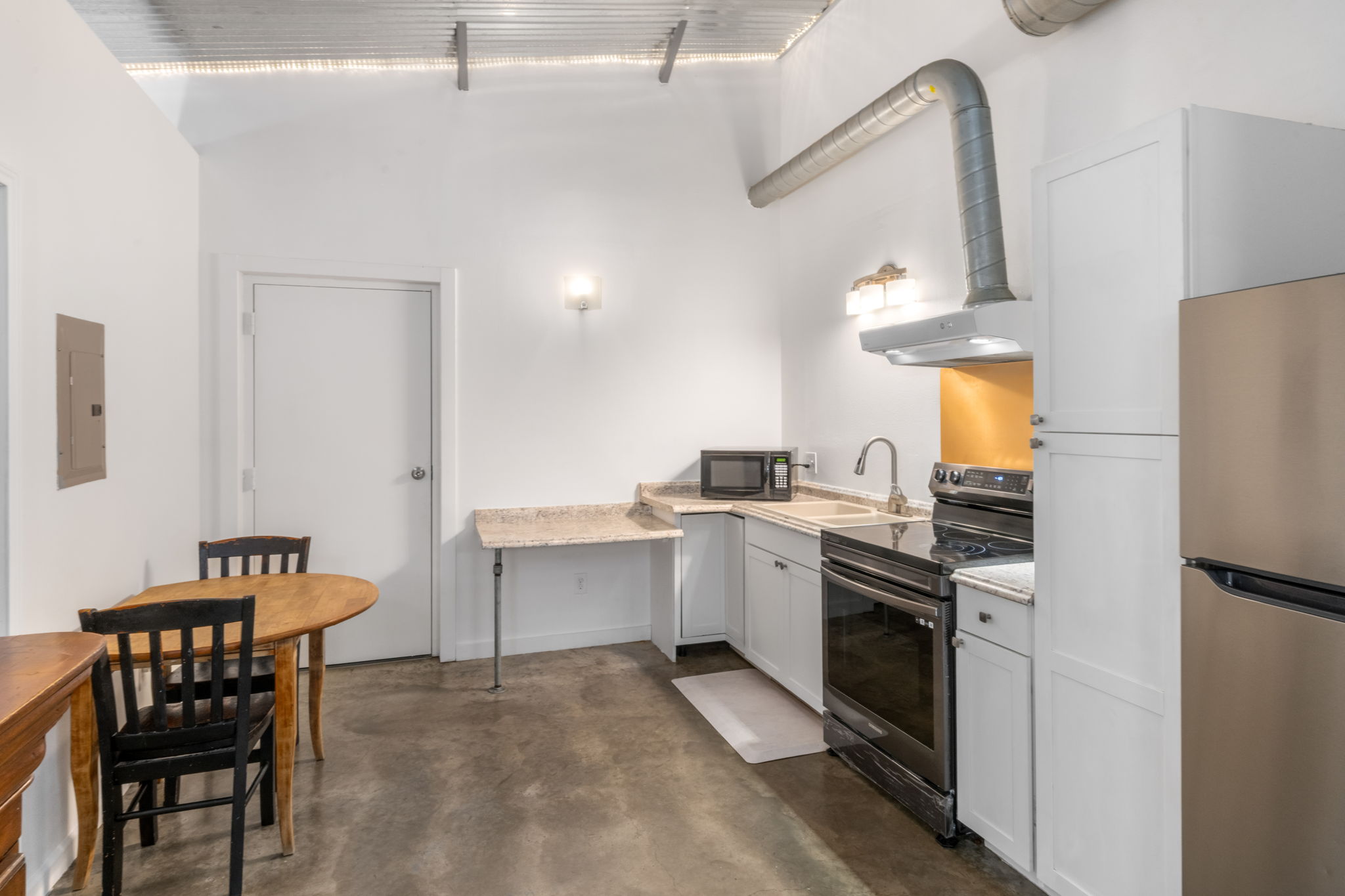 180 Henly Loop Dripping Springs, TX 78620 - Photo 28 of 38 a kitchen that has a table and chairs in it