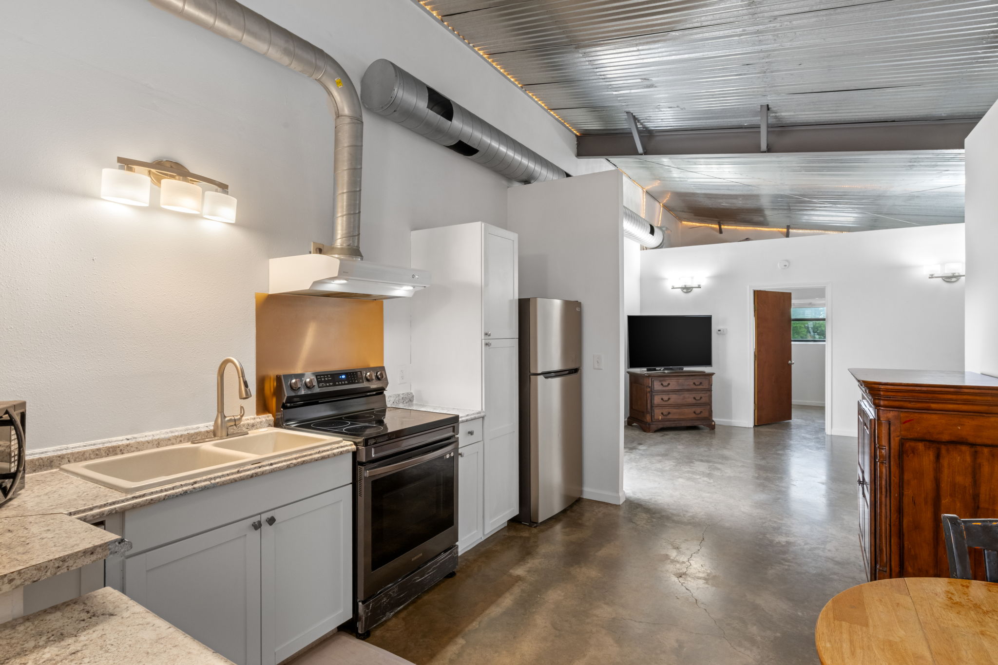 180 Henly Loop Dripping Springs, TX 78620 - Photo 29 of 38 a kitchen with a refrigerator and a stove